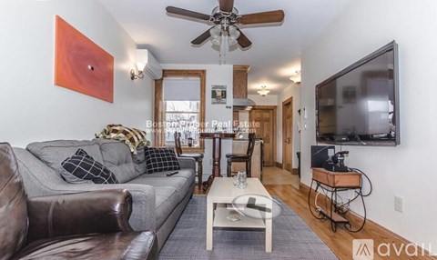 A living room with a brown leather couch and a white coffee table.