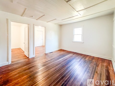 A room with wooden floors and white walls.