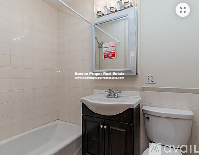 A bathroom with a tub, sink, and toilet.