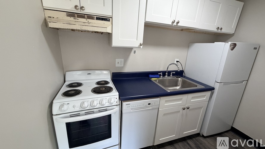 A white stove and sink in a kitchen.