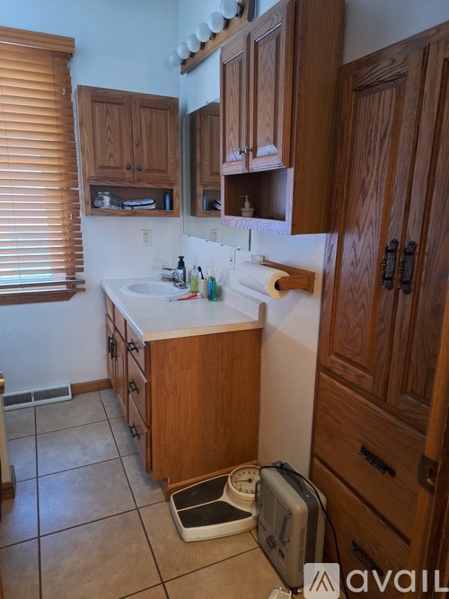 A kitchen with wooden cabinets and a white countertop.