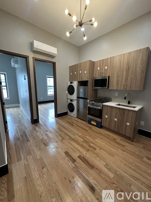 A kitchen with wooden cabinets and a wooden floor.