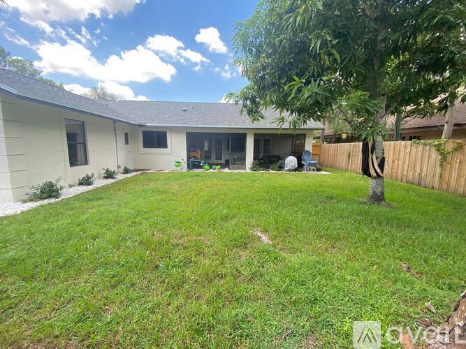 A house with a white exterior and a green lawn.