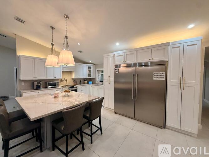 A modern kitchen with a dining table and chairs.