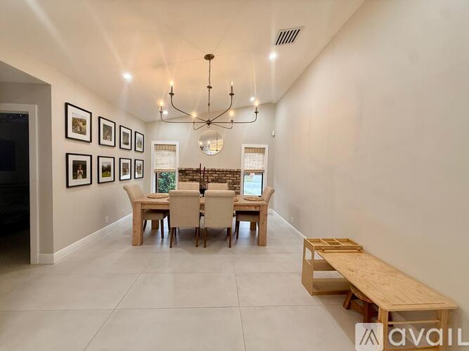 A dining room with a wooden table and chairs.
