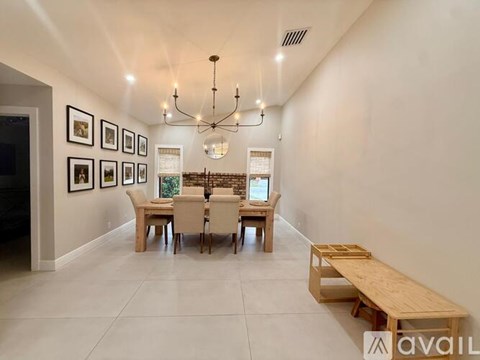 A dining room with a wooden table and chairs.