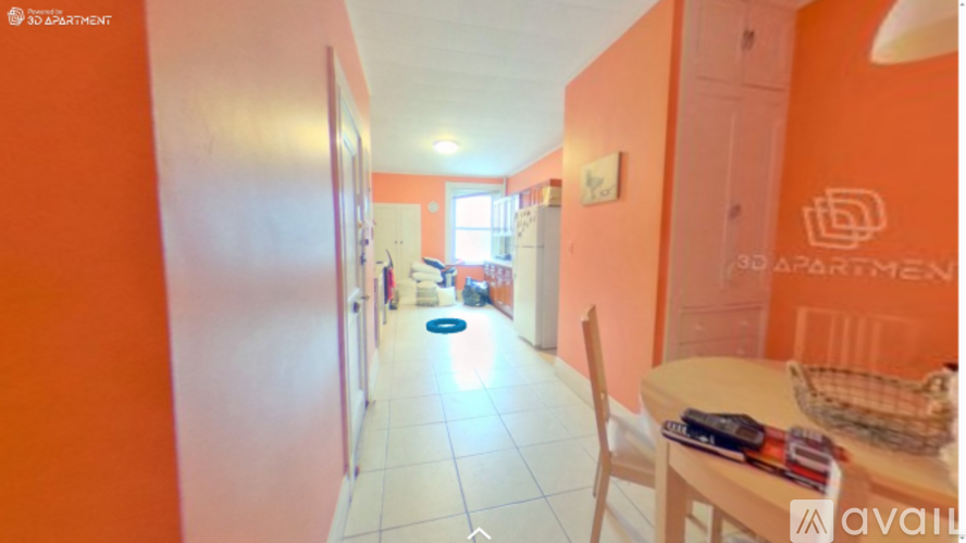 A room with orange walls and a white table with a basket on it.