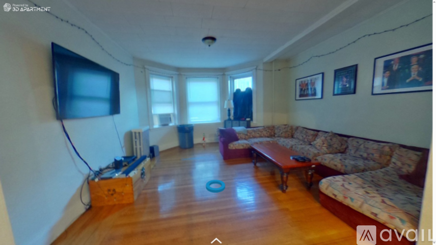 A living room with a flat screen TV mounted on the wall.
