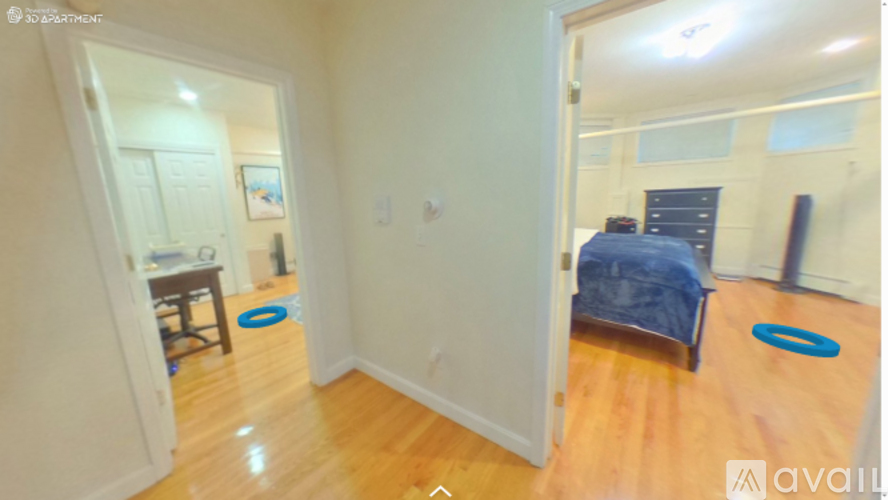 A bedroom with a bed, chair, and a blue frisbee on the floor.