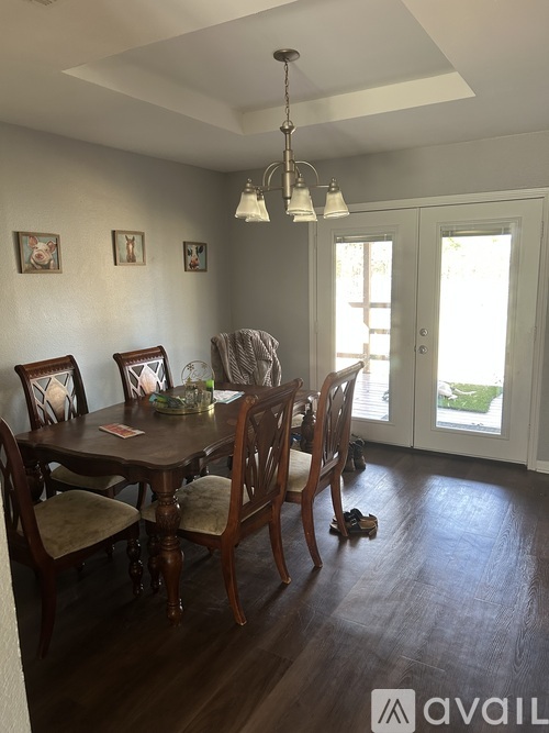 A dining room with a table set for four.