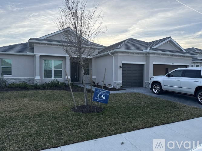 A house with a sold sign in front of it.