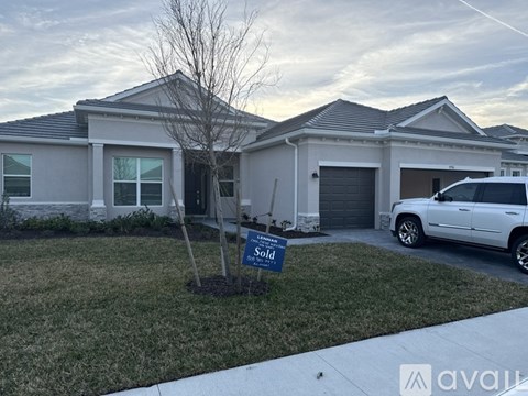 A house with a sold sign in front of it.