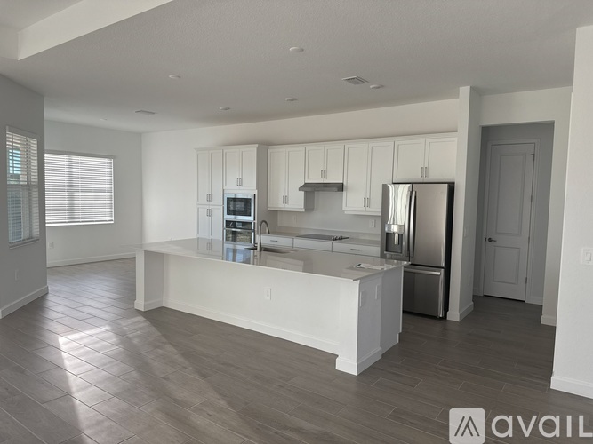 A modern kitchen with white cabinets and a central island.