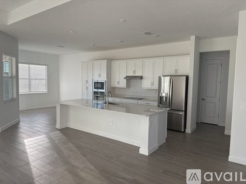 A modern kitchen with white cabinets and a central island.