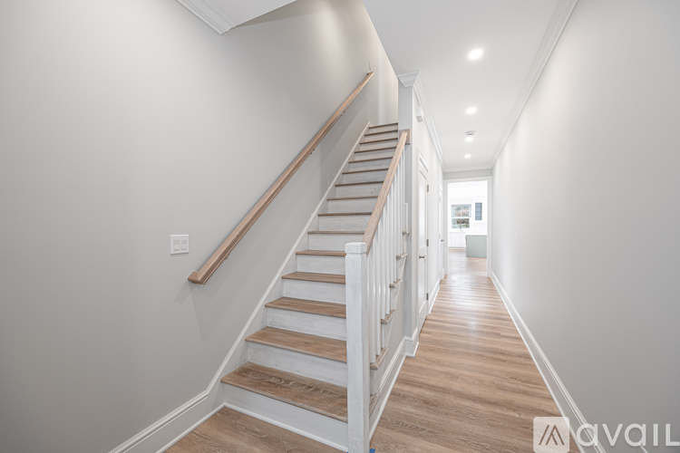 A long hallway with a staircase on the left side.