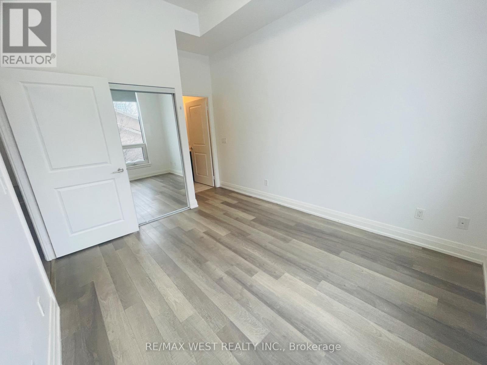 A room with a wooden floor and white walls.