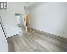 A room with a wooden floor and white walls.