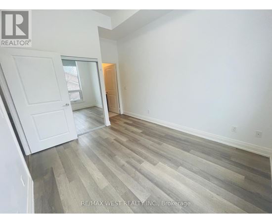 A room with a wooden floor and white walls.