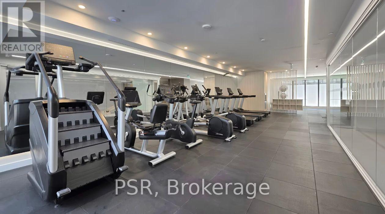 A gym with a variety of equipment including treadmills, weights, and exercise machines.