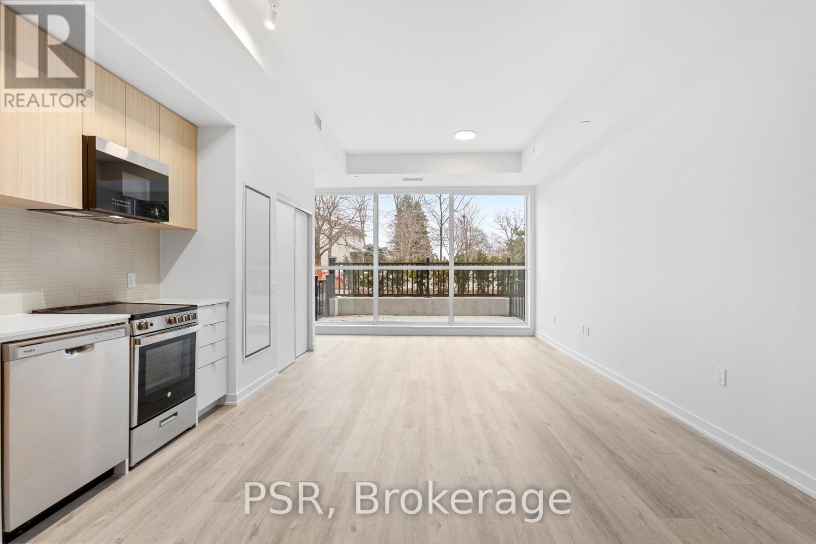 A kitchen with white appliances and wooden cabinets is on the market.