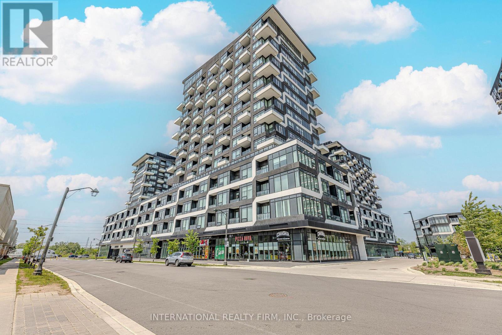 A modern multi-story building with a glass facade is the main focus of the image.