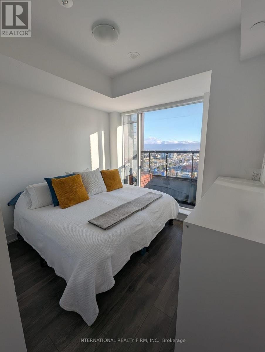 A bedroom with a large bed and a view of the city.