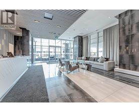 A spacious office lobby with a reception desk and comfortable seating areas.