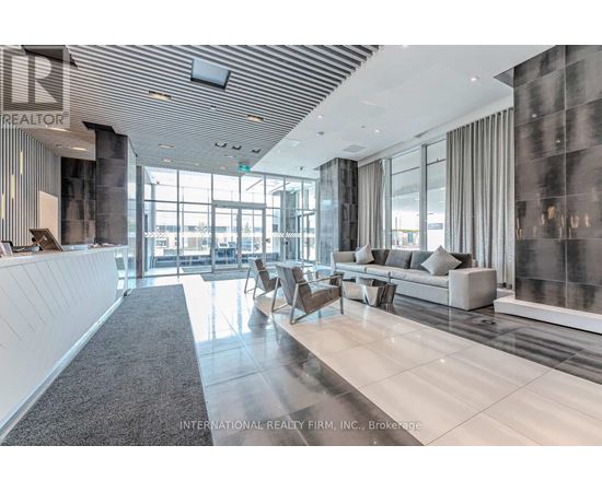A spacious office lobby with a reception desk and comfortable seating areas.