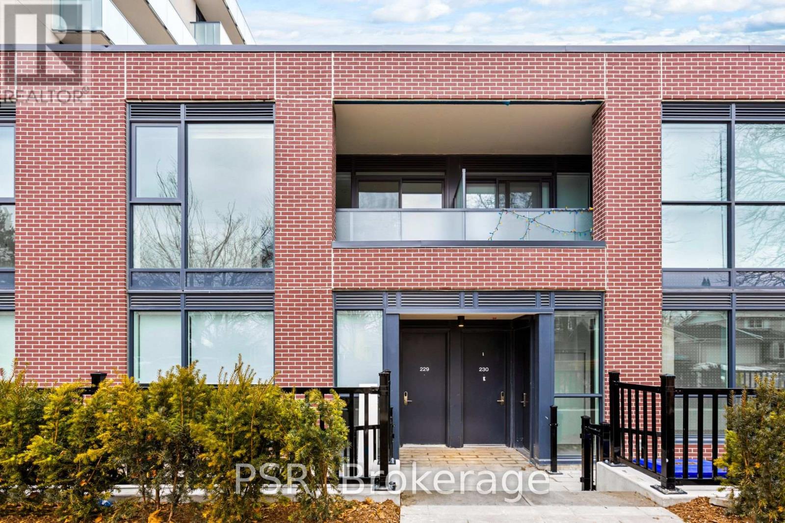 A red brick building with a black door and windows.