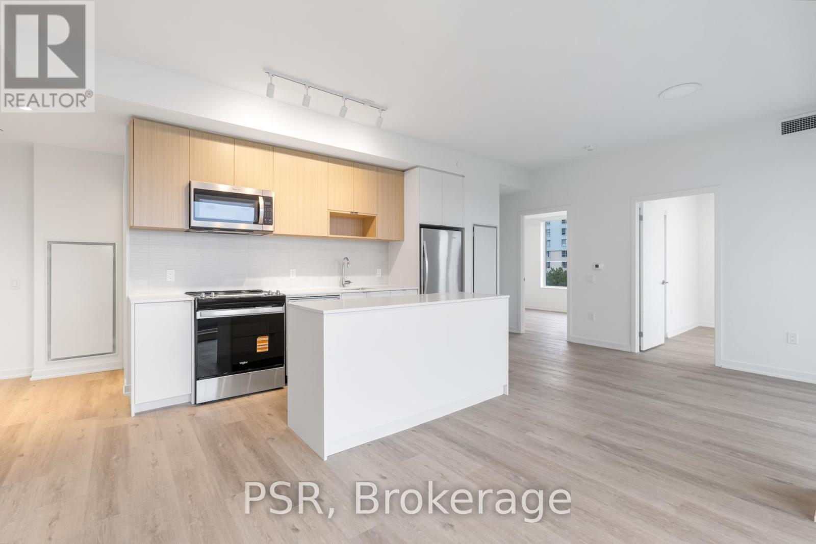 A modern kitchen with wooden cabinets and a white island.