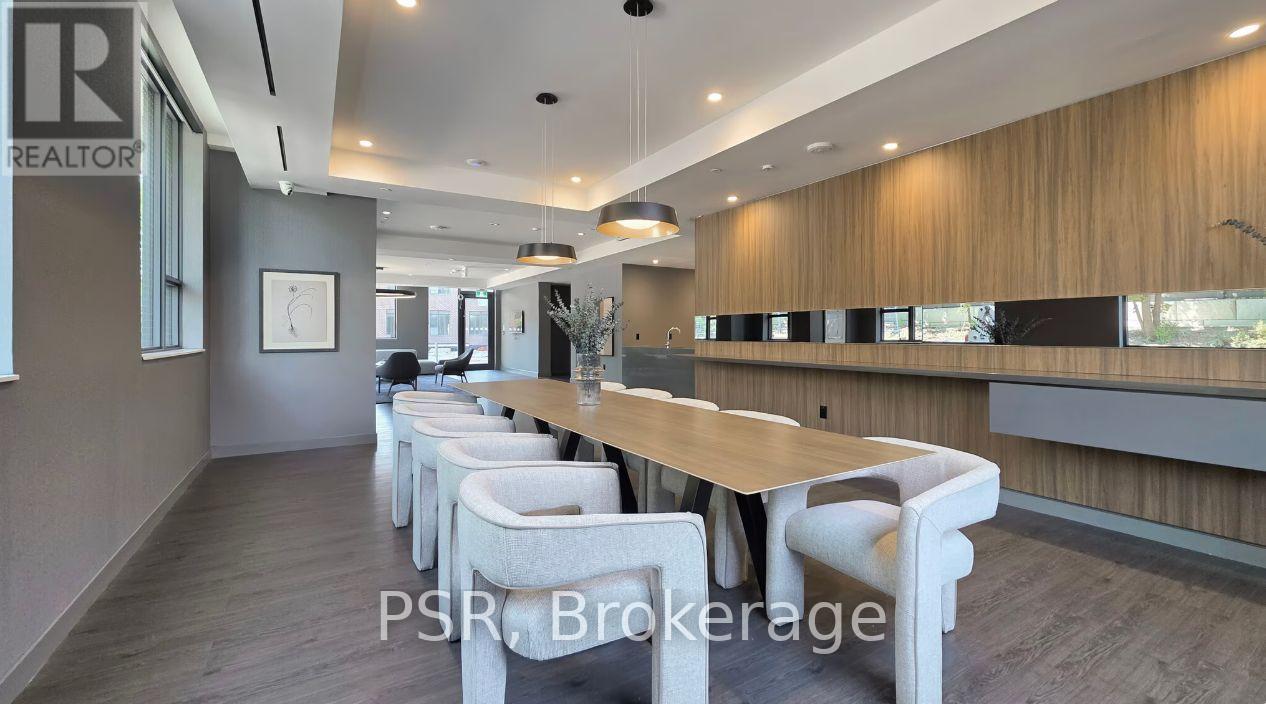 A modern dining area with a long table and chairs.