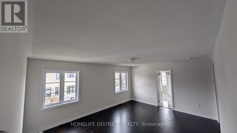 A room with a window overlooking a building.
