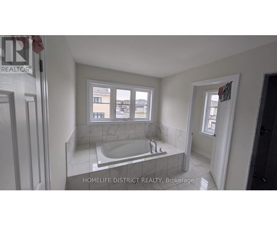 A bathroom with a tub and a window.