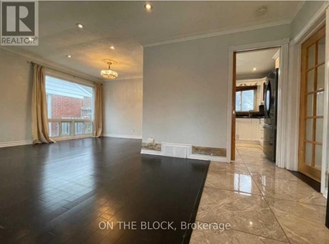 A spacious living room with a large black table and a television in the corner.