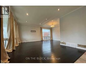 A spacious room with a black floor and beige curtains.