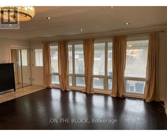 A spacious room with a large window and a flat-screen TV.