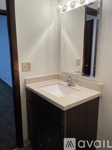 A bathroom sink with a mirror above it.