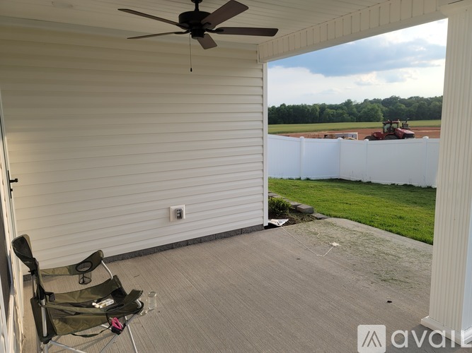 A patio with a fan and a chair is shown.