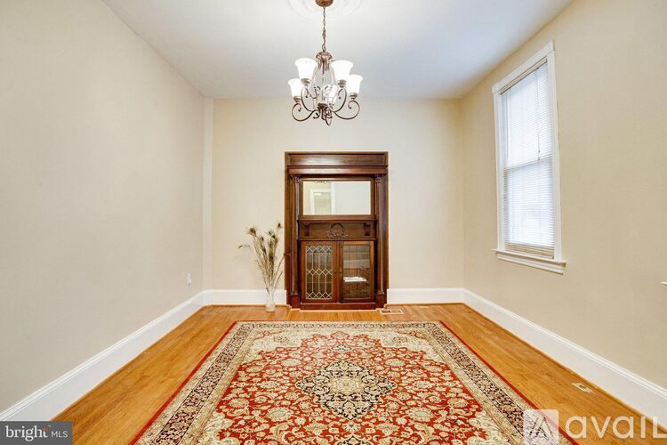 A room with a wooden door and a chandelier.
