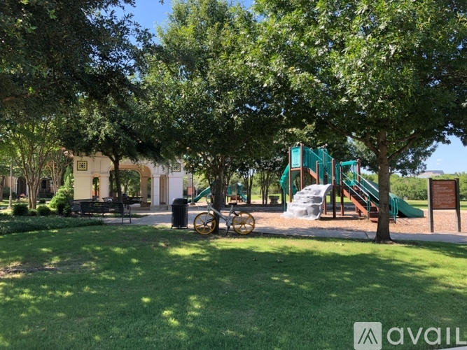 A playground with a green slide and a wooden bench.
