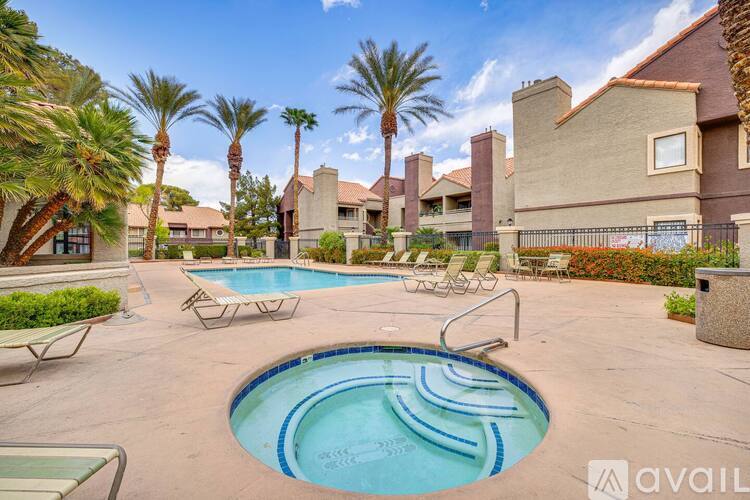 A pool surrounded by palm trees and lounge chairs.