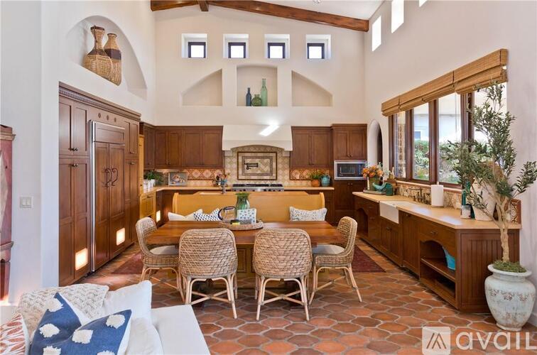 A kitchen with a table and chairs in the middle of the room.