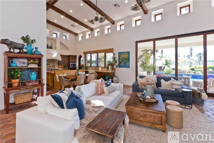 A living room with a white couch and a wooden coffee table.
