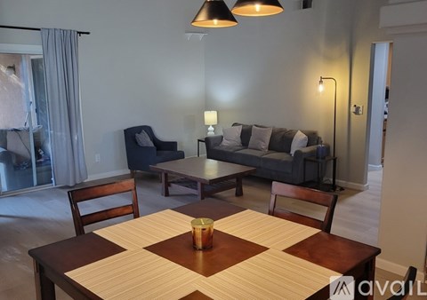 A living room with a couch, chair, and table.