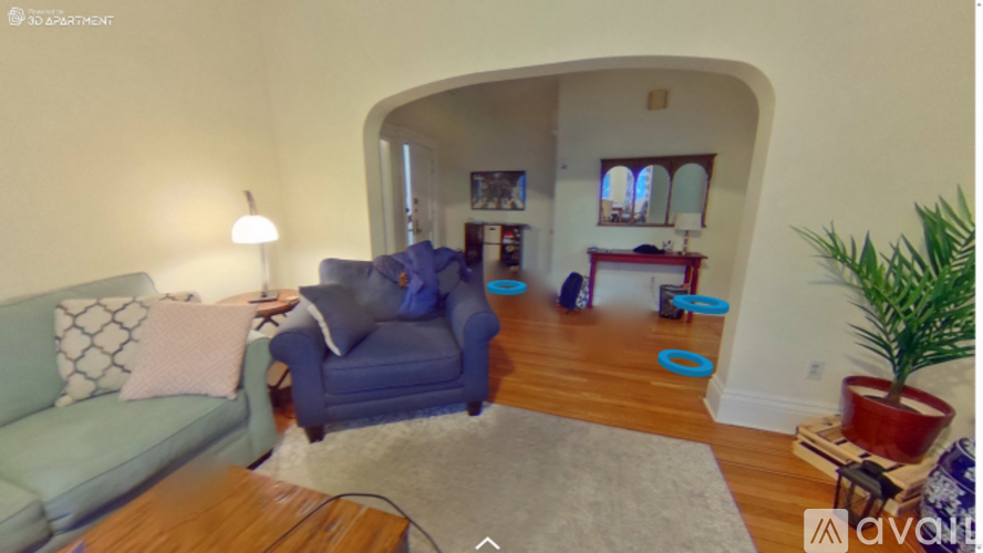 A living room with a blue couch and a wooden coffee table.