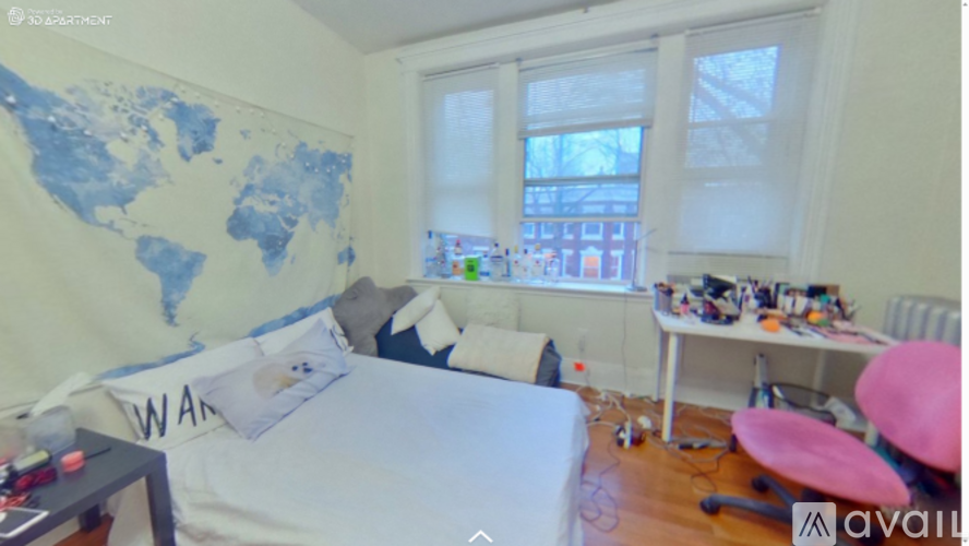A room with a bed, desk, and chair.