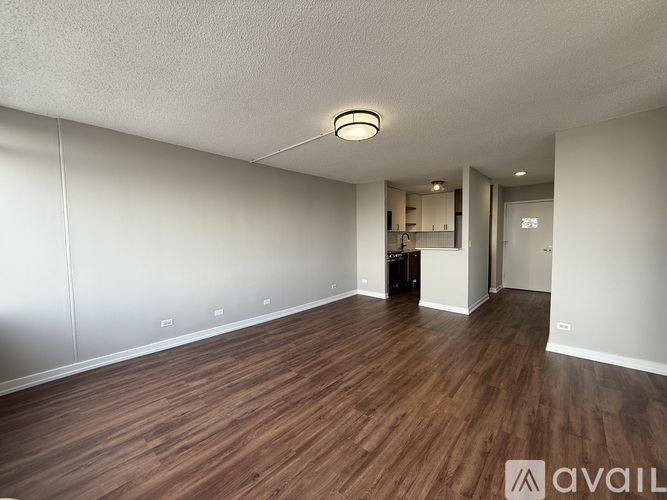 A room with wooden flooring and white walls.