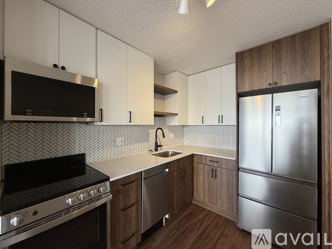 A modern kitchen with wooden cabinets and stainless steel appliances.