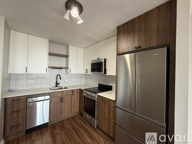A kitchen with wooden cabinets and stainless steel appliances.