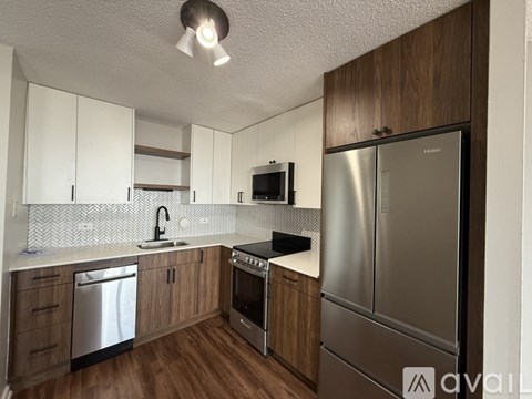 A kitchen with wooden cabinets and stainless steel appliances.